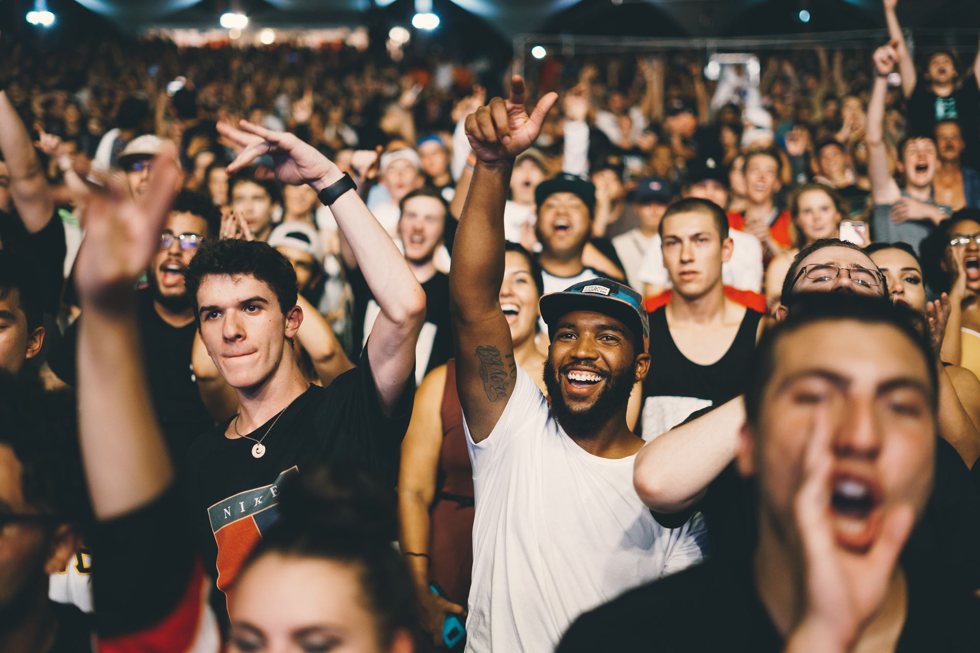 a group of people standing in front of a crowd posing for the camera